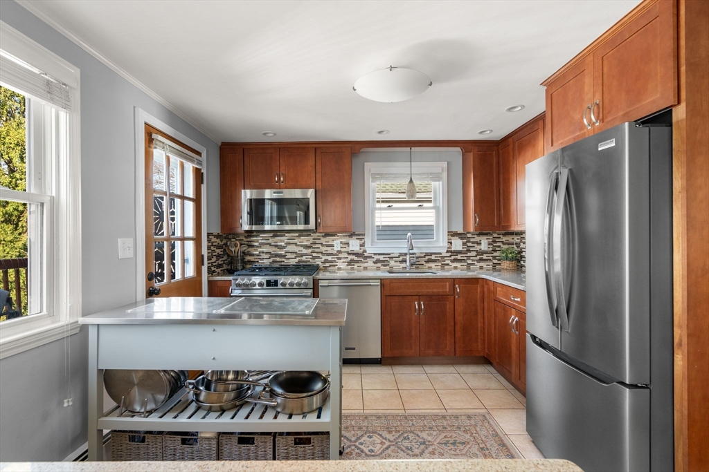 64 Newfield Street Boston, MA 02132 - Photo 15 of 36 a kitchen with stainless steel appliances granite countertop a refrigerator and a stove top oven