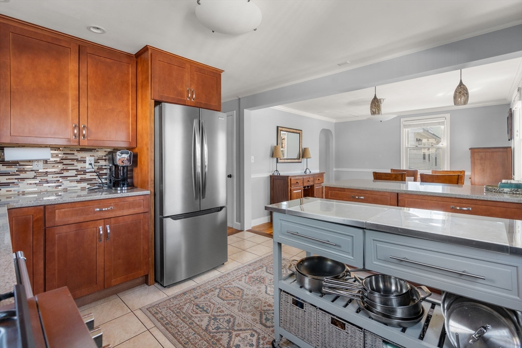64 Newfield Street Boston, MA 02132 - Photo 16 of 36 a kitchen with stainless steel appliances granite countertop a sink stove and refrigerator