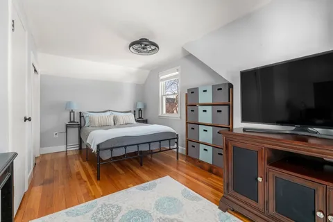 a bedroom with a bed and a flat screen tv