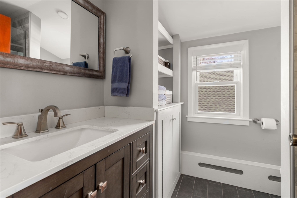 64 Newfield Street Boston, MA 02132 - Photo 22 of 36 a bathroom with a sink and a mirror