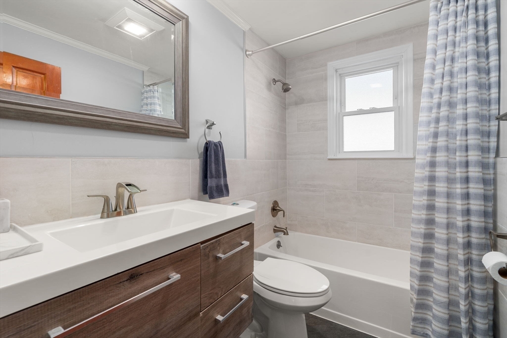 64 Newfield Street Boston, MA 02132 - Photo 26 of 36 a bathroom with a sink mirror toilet and bathtub