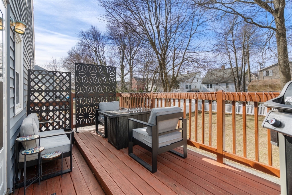 64 Newfield Street Boston, MA 02132 - Photo 27 of 36 a view of a roof deck with wooden fence and wooden floor