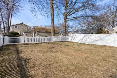 a view of backyard with large trees