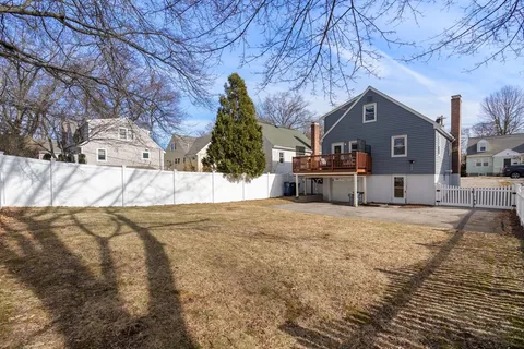 a view of a house with a yard covered in snow