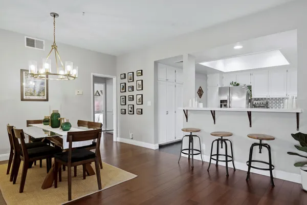 a view of a dining room with furniture and wooden floor