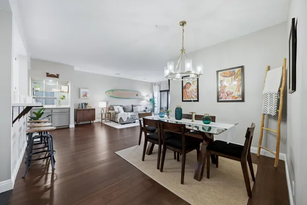 a view of a dining room with furniture wooden floor and chandelier