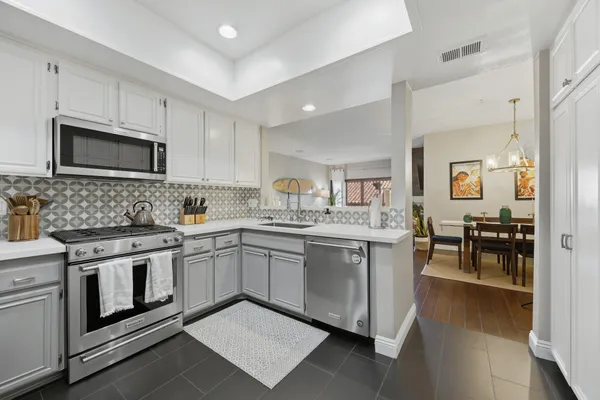 a kitchen with granite countertop appliances cabinets and furniture