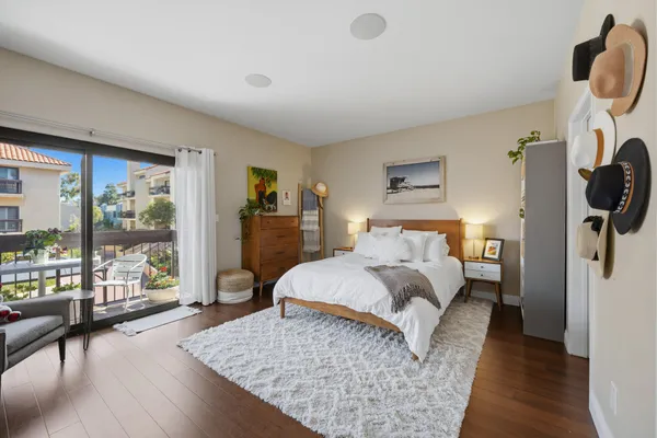 a bedroom with a bed a couch and dresser