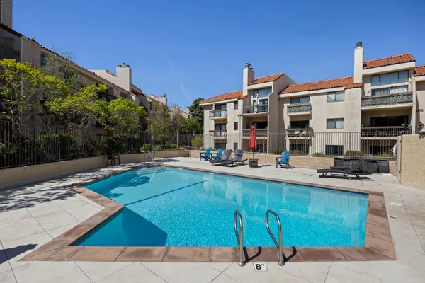 a view of a patio with swimming pool table and chairs