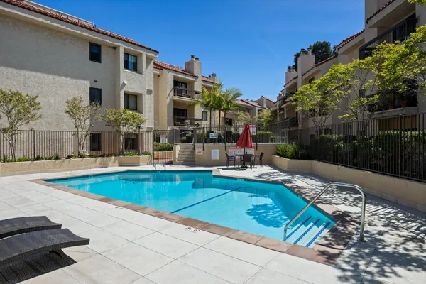 a view of a patio with swimming pool table and chairs