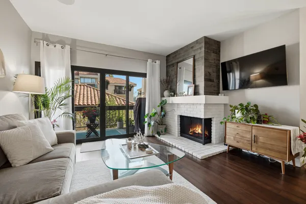 a living room with furniture fireplace and flat screen tv