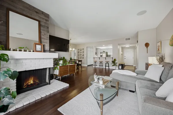 a living room with furniture a flat screen tv and a fireplace