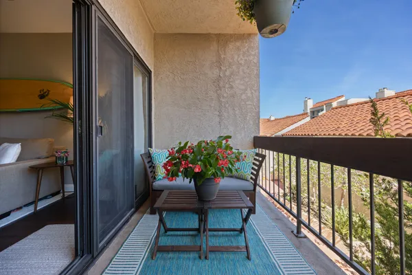a view of a balcony with furniture