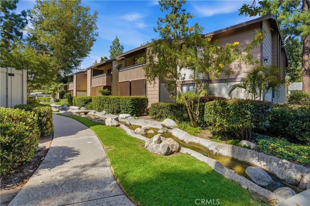 20702 El Toro Road, Unit 231 Lake Forest, CA 92630 - Photo 32 of 36 a front view of a house with garden