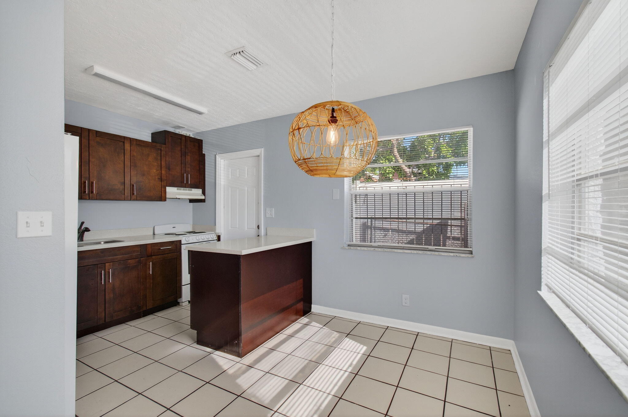 109 Southeast 11th Avenue, Unit 13 Pompano Beach, FL 33060 - Photo 11 of 37 a kitchen with stainless steel appliances granite countertop a stove a sink and a refrigerator