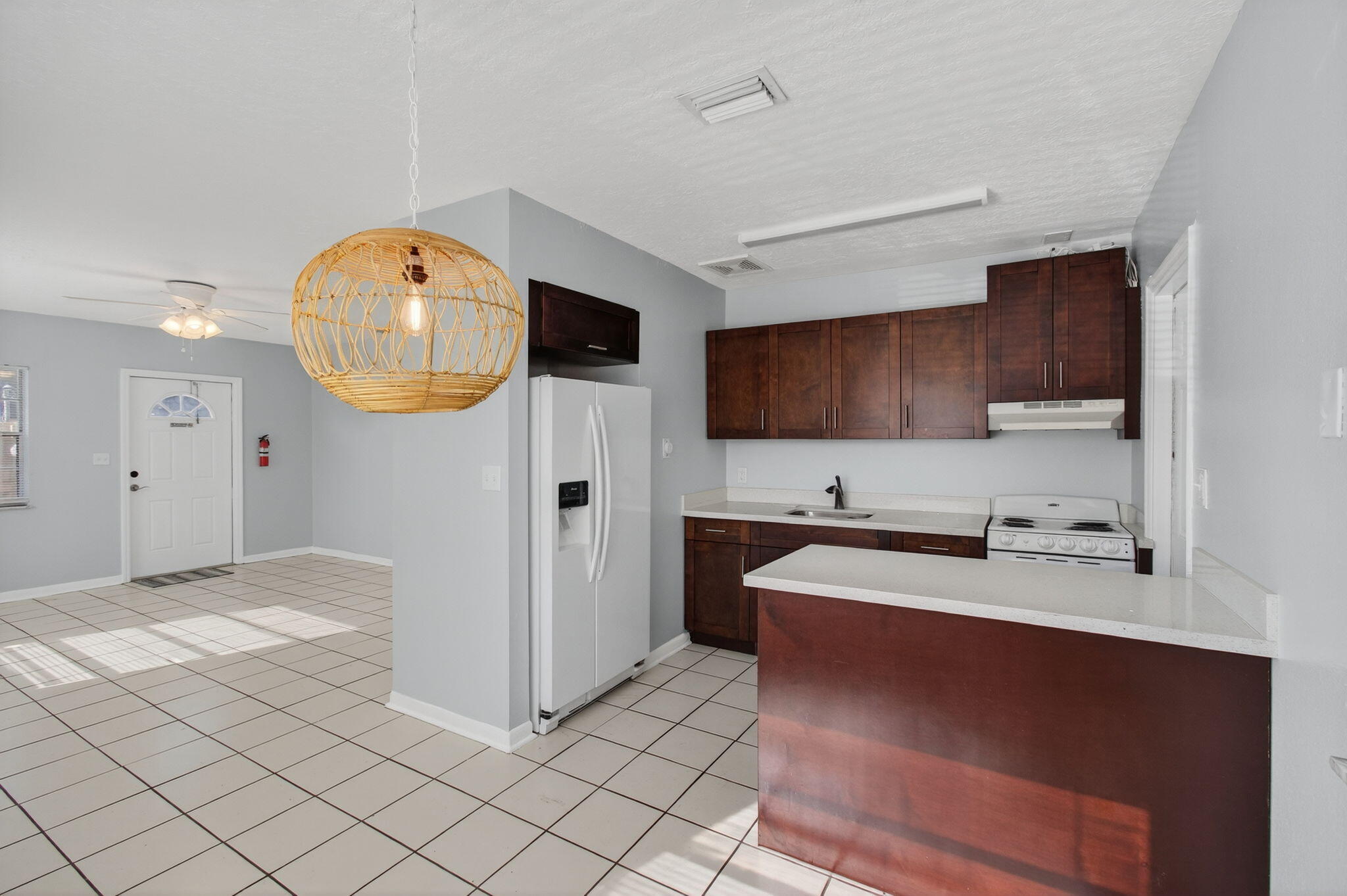 109 Southeast 11th Avenue, Unit 13 Pompano Beach, FL 33060 - Photo 12 of 37 a kitchen with stainless steel appliances a stove a sink a microwave a refrigerator and cabinets
