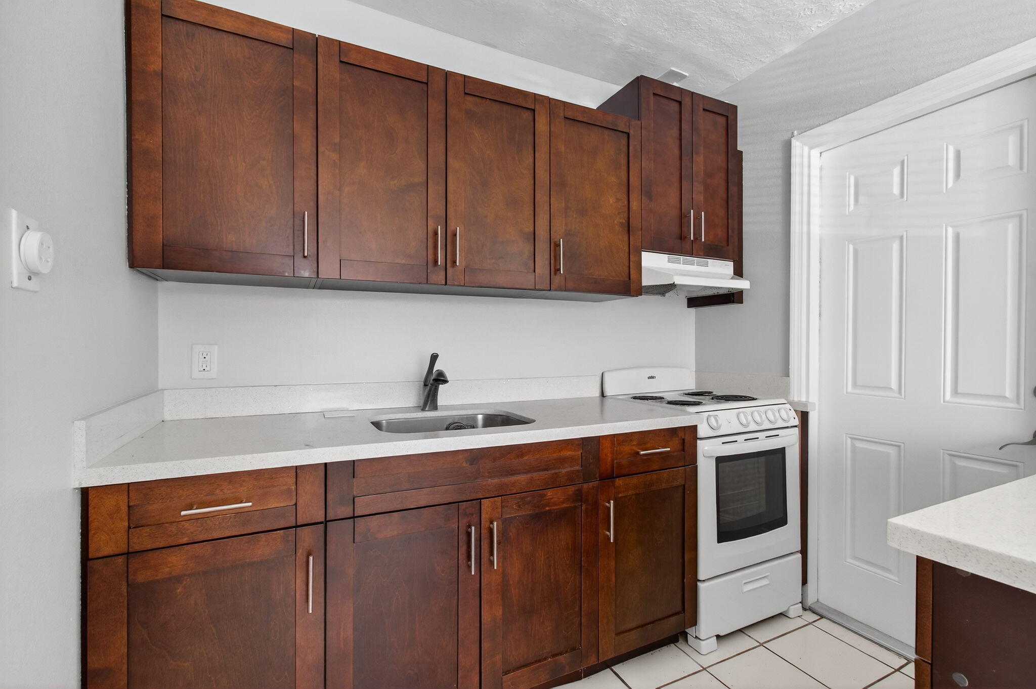 109 Southeast 11th Avenue, Unit 13 Pompano Beach, FL 33060 - Photo 13 of 37 a kitchen with stainless steel appliances granite countertop a sink stove and cabinets
