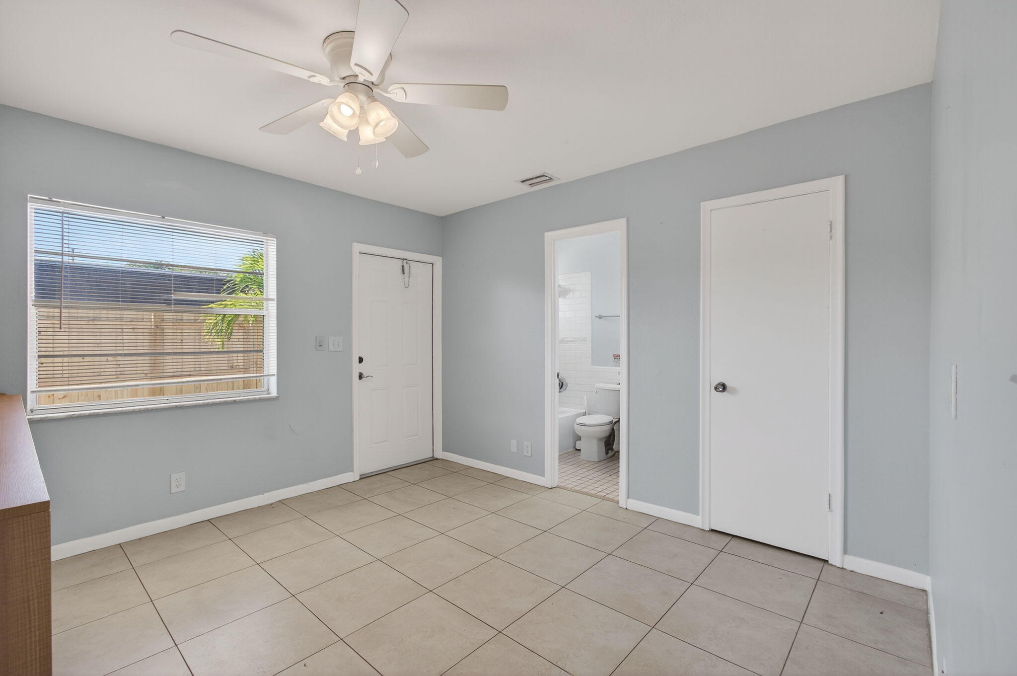 109 Southeast 11th Avenue, Unit 13 Pompano Beach, FL 33060 - Photo 14 of 37 a view of an empty room with window and cabinet