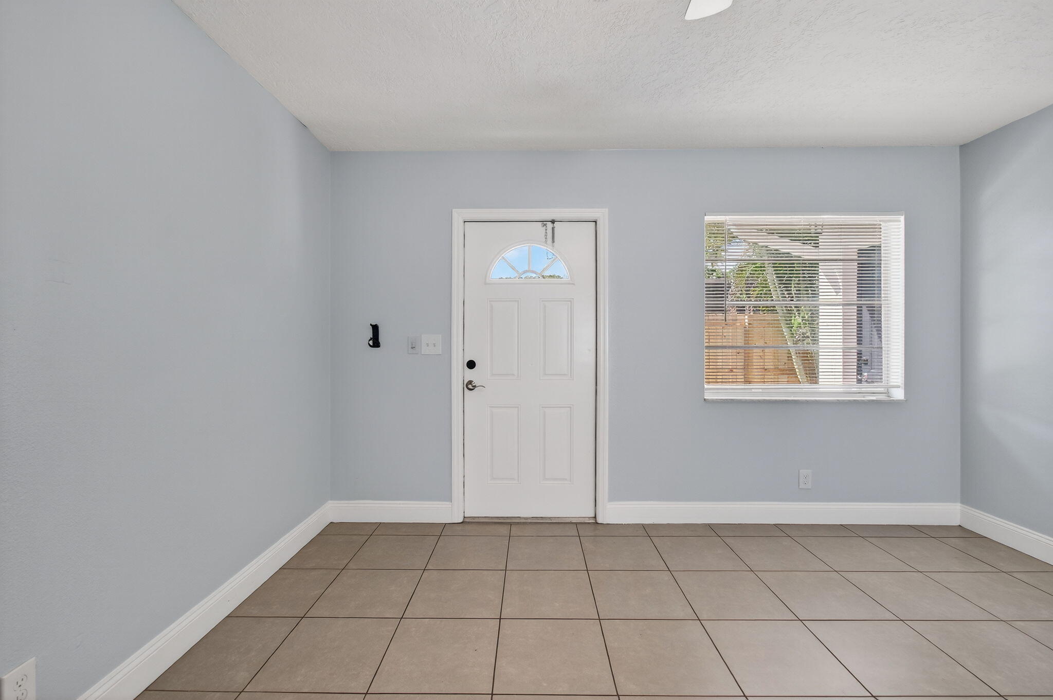109 Southeast 11th Avenue, Unit 13 Pompano Beach, FL 33060 - Photo 23 of 37 an empty room with windows