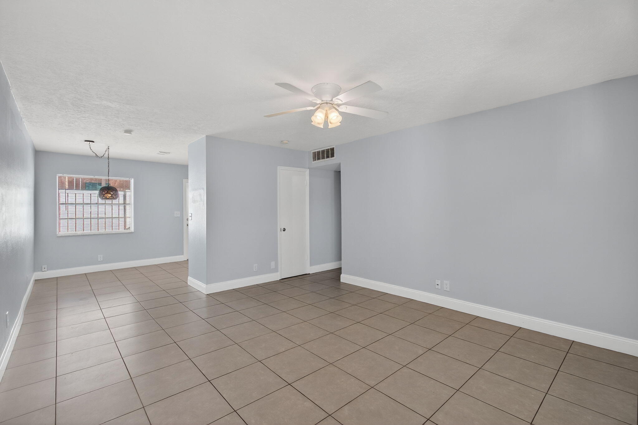 109 Southeast 11th Avenue, Unit 13 Pompano Beach, FL 33060 - Photo 24 of 37 an empty room with windows and fan