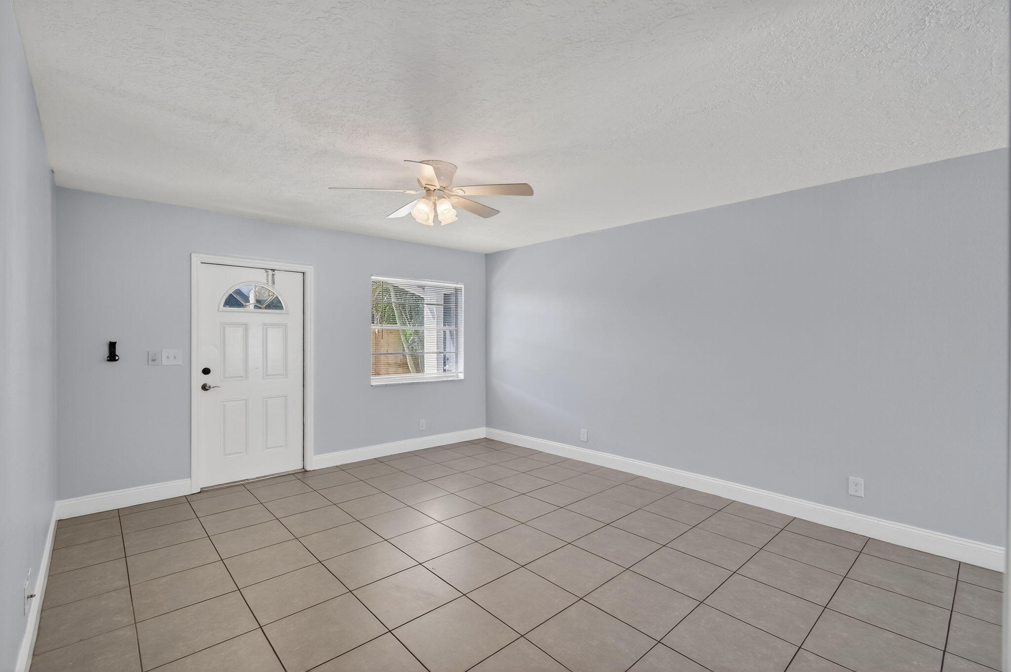 109 Southeast 11th Avenue, Unit 13 Pompano Beach, FL 33060 - Photo 25 of 37 a view of an empty room with window