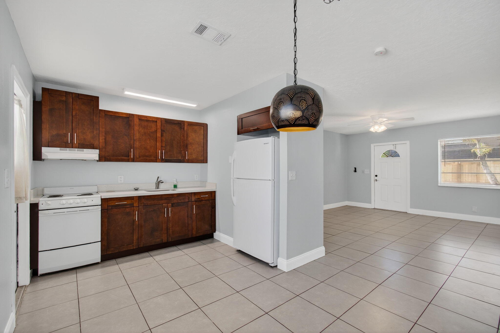 109 Southeast 11th Avenue, Unit 13 Pompano Beach, FL 33060 - Photo 27 of 37 a kitchen with stainless steel appliances granite countertop a stove a sink and a refrigerator