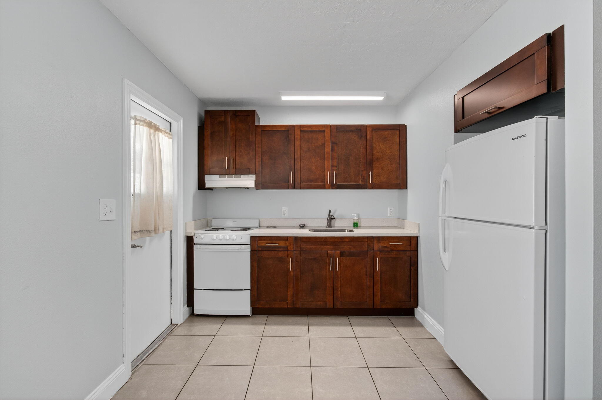 109 Southeast 11th Avenue, Unit 13 Pompano Beach, FL 33060 - Photo 28 of 37 a kitchen with a refrigerator sink and cabinets