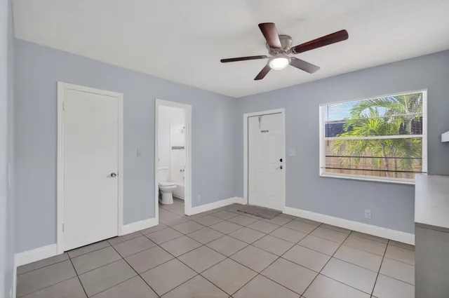 a view of a livingroom with a ceiling fan and window