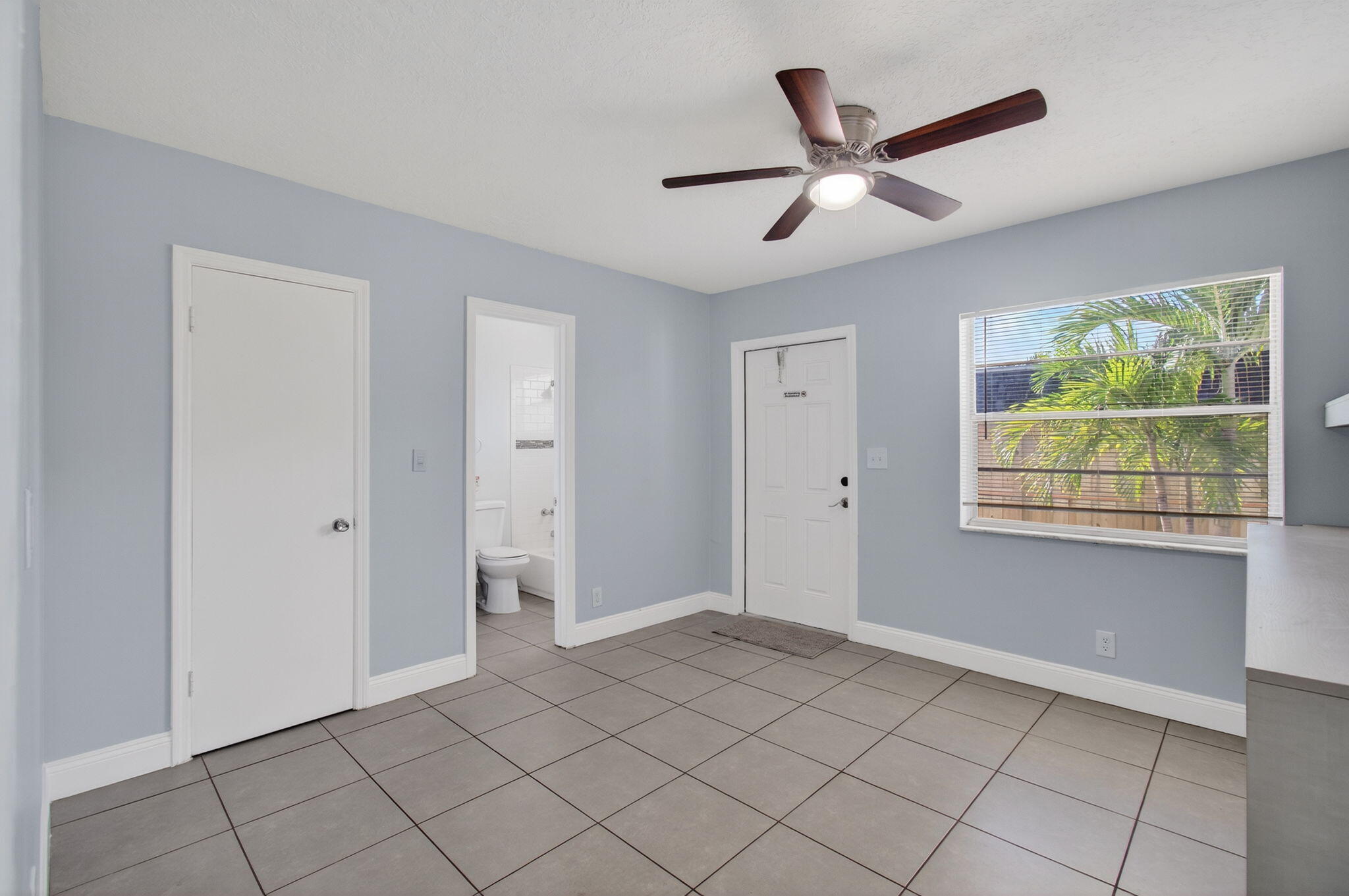 109 Southeast 11th Avenue, Unit 13 Pompano Beach, FL 33060 - Photo 29 of 37 a view of a livingroom with a ceiling fan and window