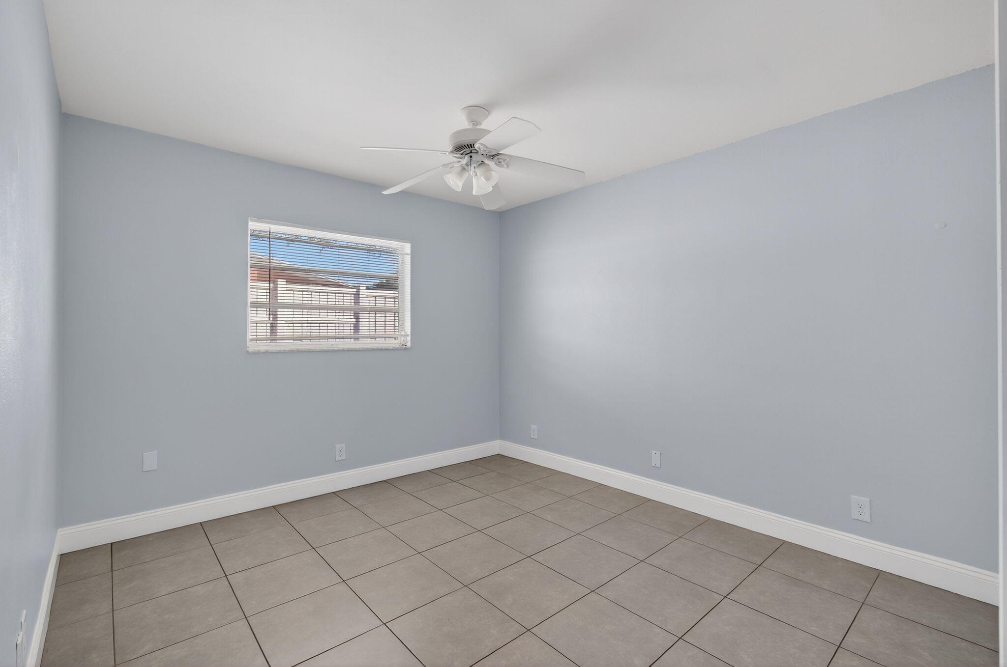 109 Southeast 11th Avenue, Unit 13 Pompano Beach, FL 33060 - Photo 33 of 37 an empty room with chandelier fan