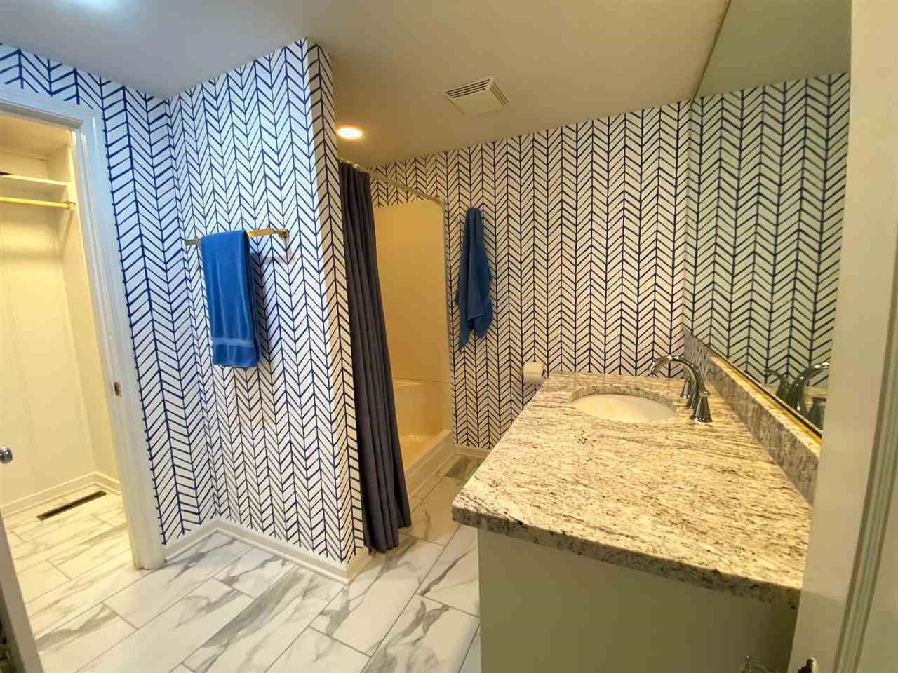 225 East 3rd Street Henderson, TN 38340 - Photo 18 of 22 a bathroom with a sink and mirror