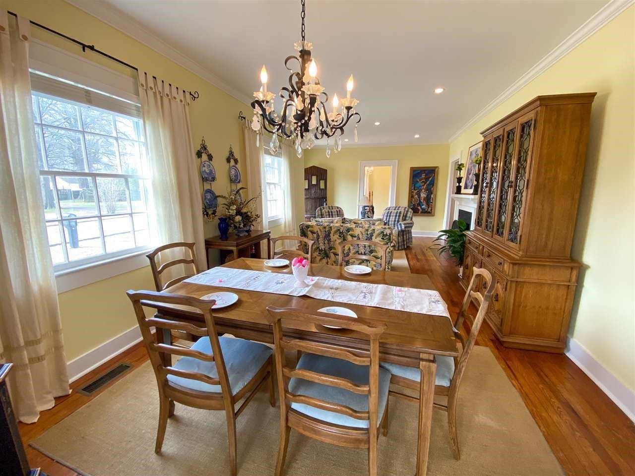 225 East 3rd Street Henderson, TN 38340 - Photo 6 of 22 a view of a dining room with furniture a chandelier and wooden floor