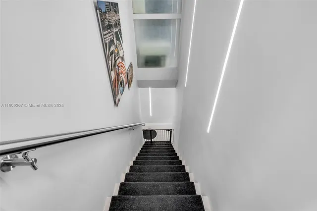 a bedroom with a bed a table and a large mirror