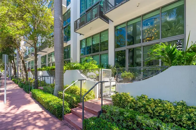 a view of a chair and tables in the patio in front of the house