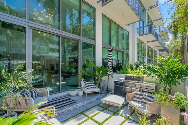 a view of a chair and table in backyard of the house