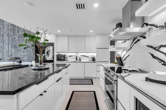 a kitchen with a sink stainless steel appliances and counter space