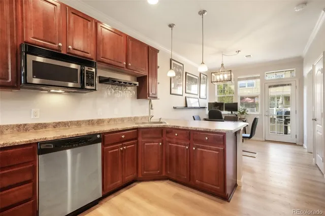 a kitchen with granite countertop wooden cabinets and a sink