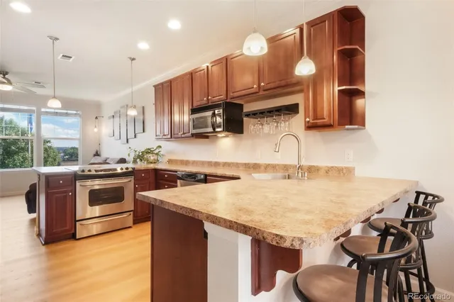 a view of a dining room with furniture a kitchen and chandelier