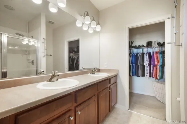 a bathroom with a double vanity sink and a mirror