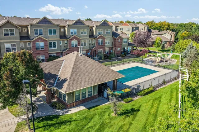 an aerial view of a house with a yard and potted plants