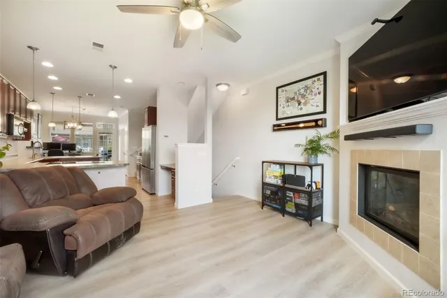 a living room with furniture and kitchen view