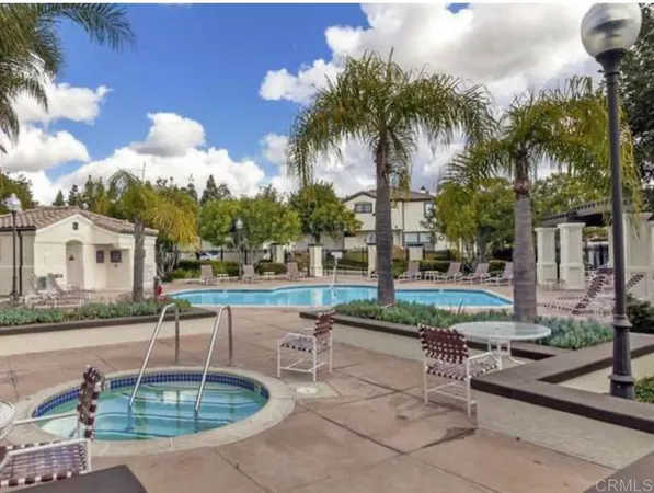 a swimming pool with outdoor seating and yard