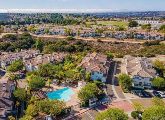 an aerial view of residential houses with outdoor space