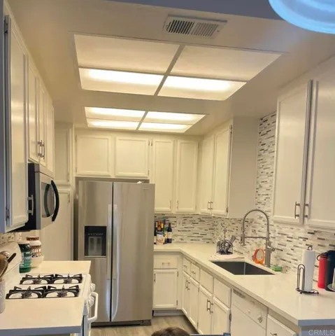 a kitchen with a sink stove and refrigerator