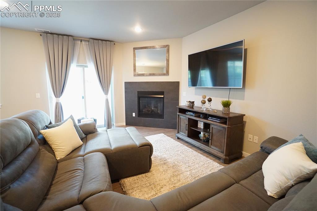 5309 Passport View Colorado Springs, CO 80922 - Photo 11 of 33 a living room with furniture a flat screen tv and a fireplace