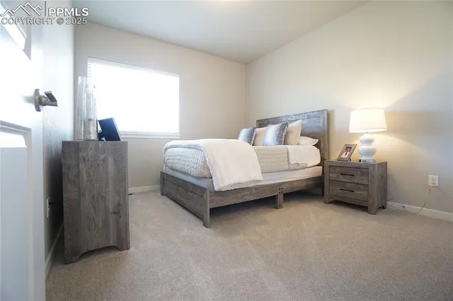 a spacious bedroom with a bed and a window