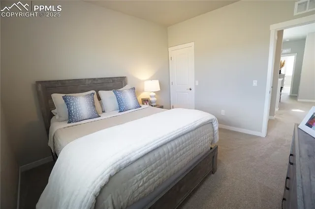 a bedroom with a bed and a night stand