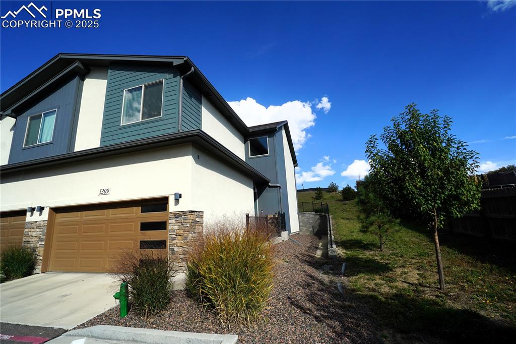5309 Passport View Colorado Springs, CO 80922 - Photo 2 of 33 a front view of a house with garden