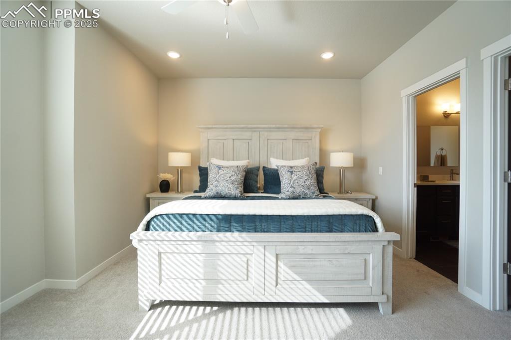 5309 Passport View Colorado Springs, CO 80922 - Photo 26 of 33 a spacious bedroom with a bed and a lamp