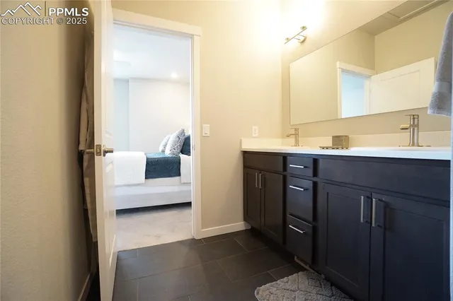 a en suite bathroom with a sink and a mirror